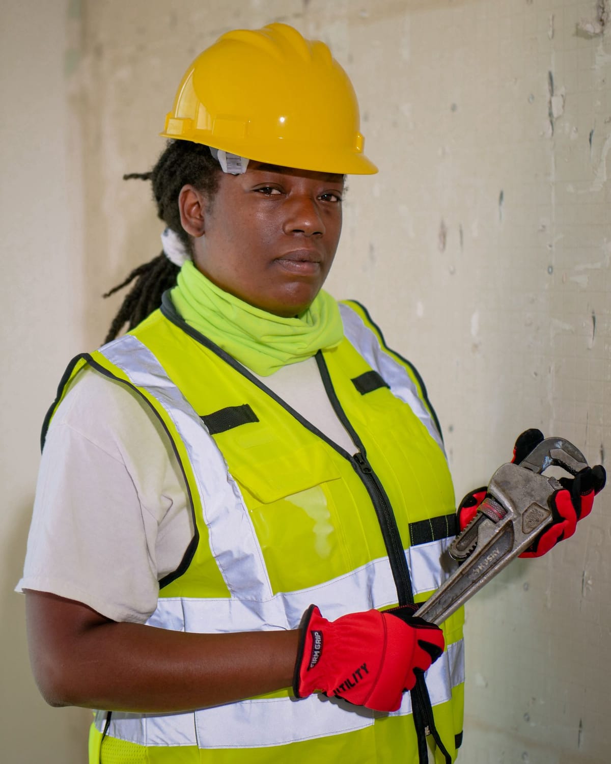 Plumber with a pipe wrench on site