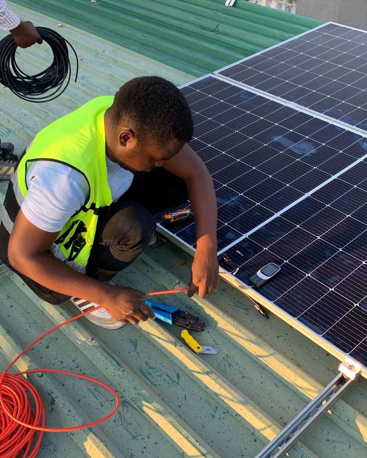 Solar technician installing rooftop panels